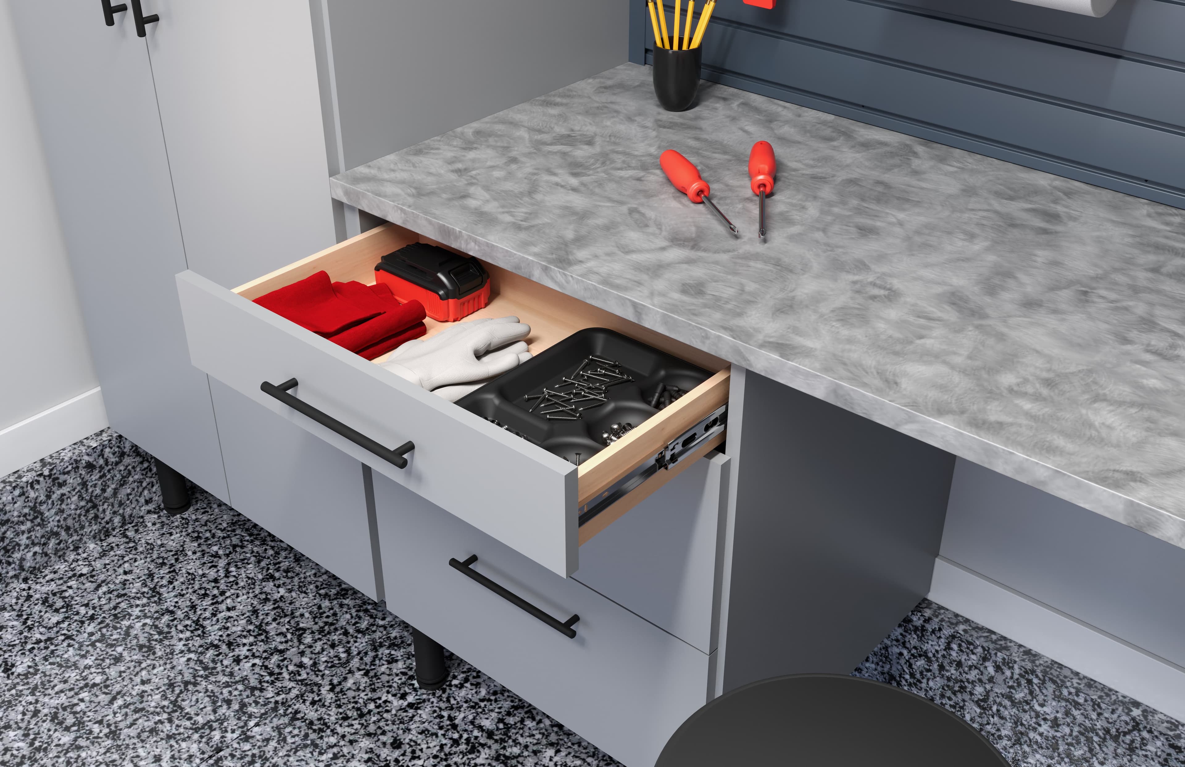 Open garage drawer with a tool tray beside a speckled work surface