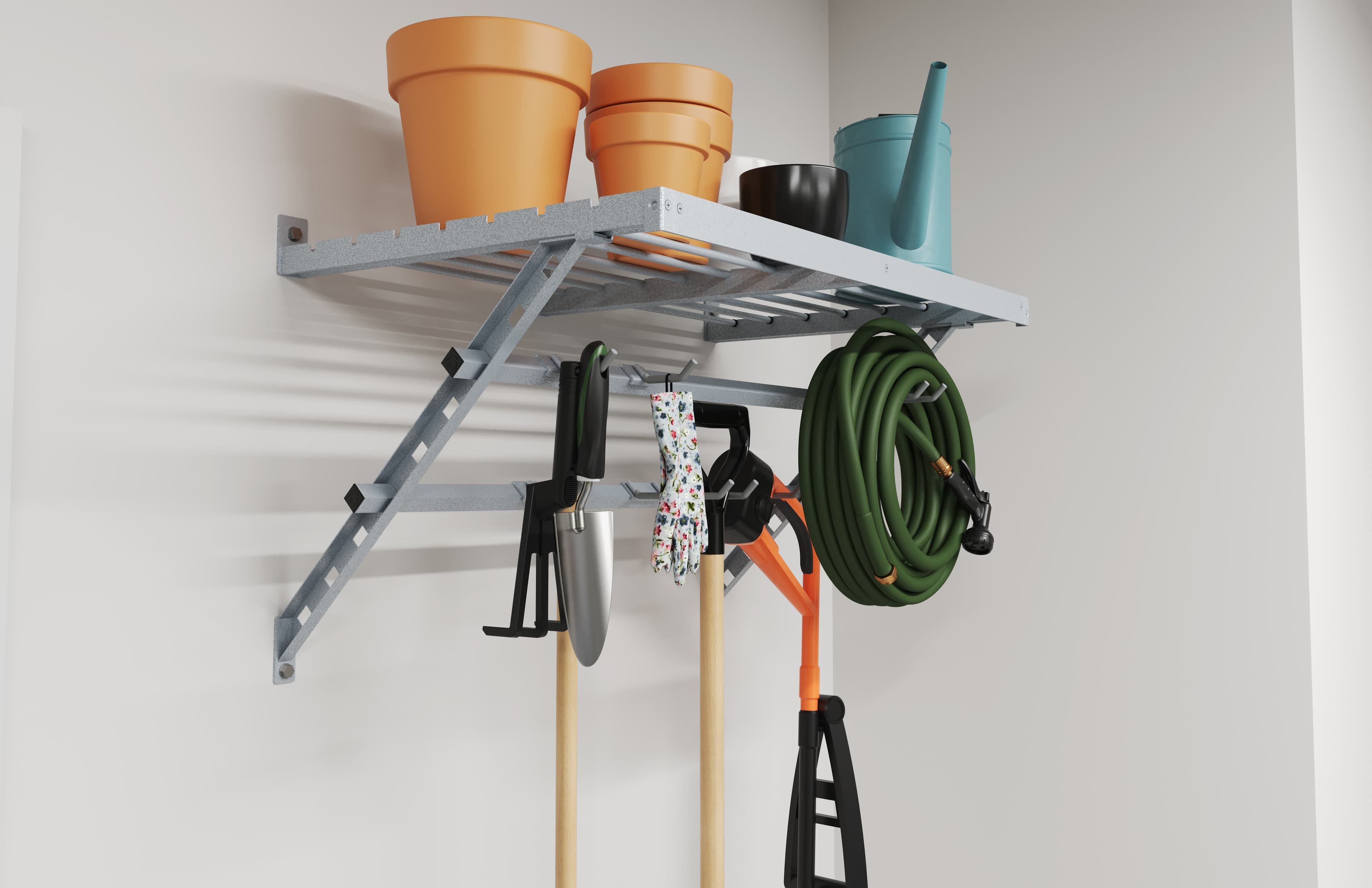 Wall-mounted garage shelf with hanging garden tools and a hose