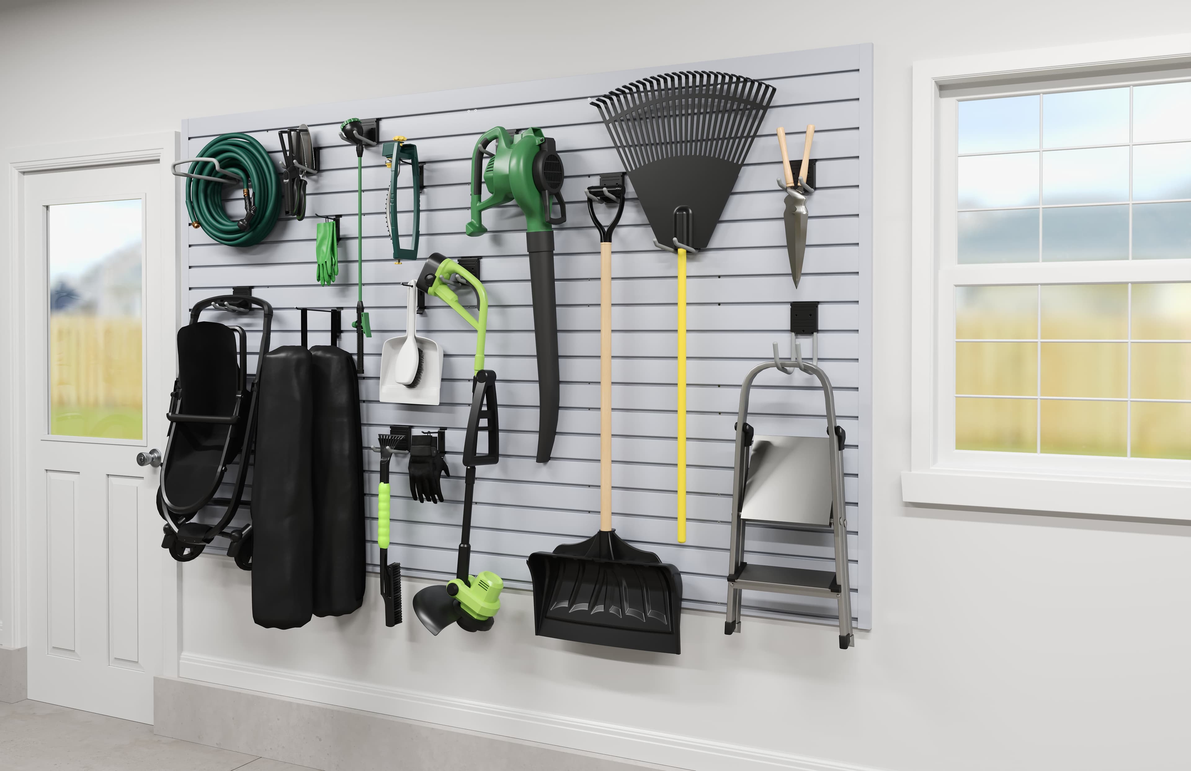 Garage slatwall organized with hoses, tools, and seasonal gear