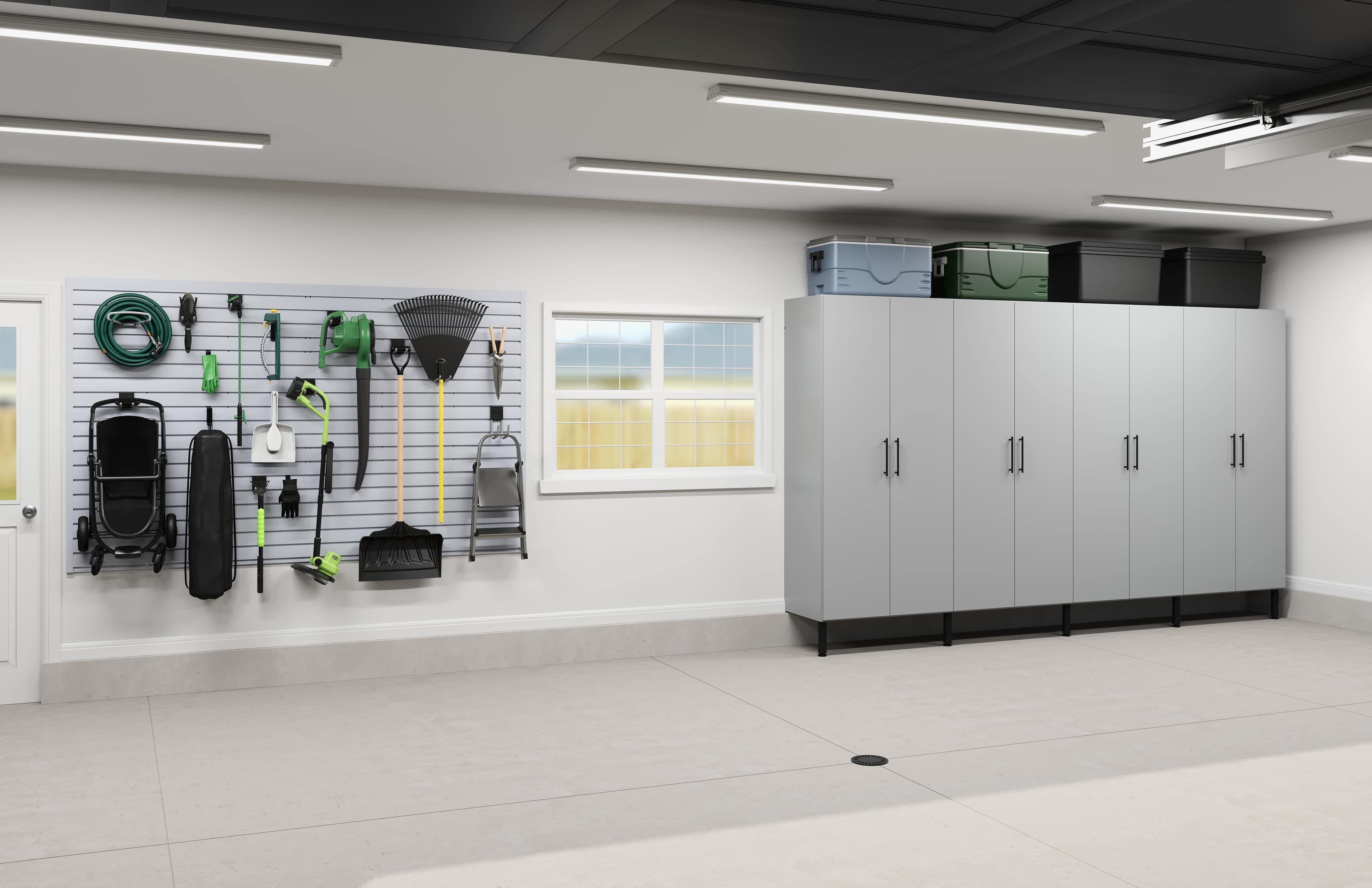 Tall gray garage cabinets with a slatwall of yard tools