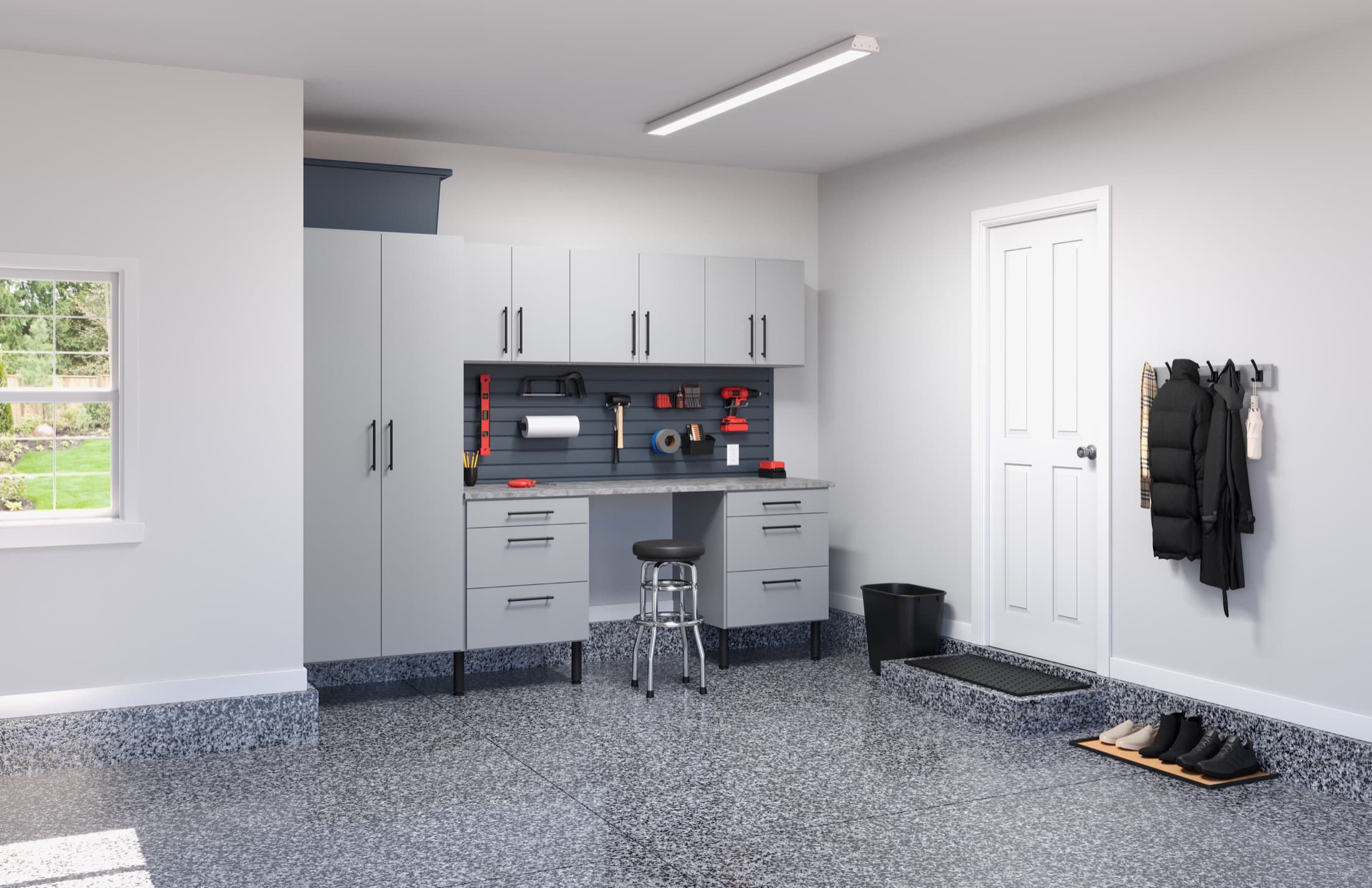 Clean white garage storage system with workbench and tall cabinets