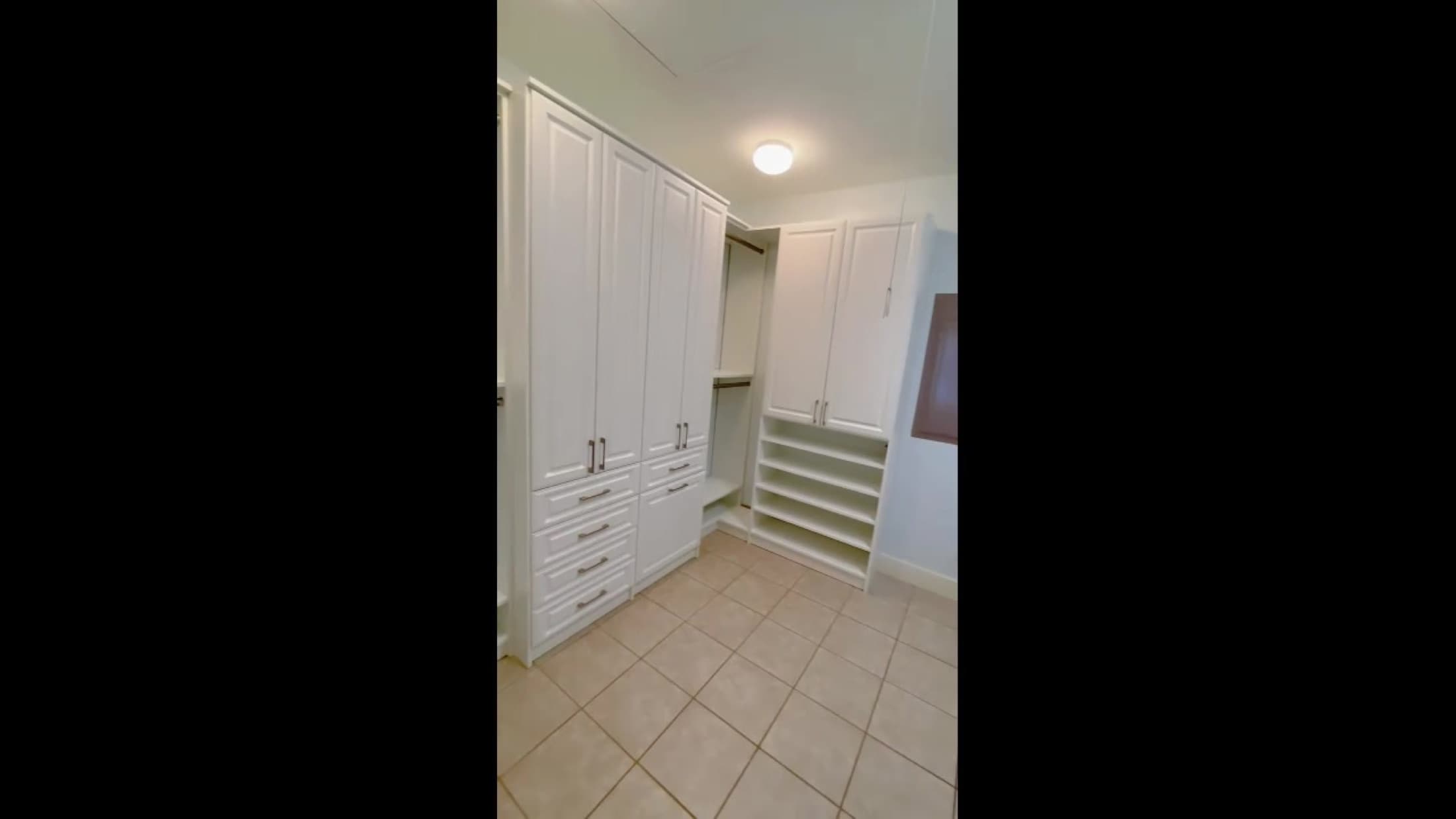 White laundry room cabinetry built around washer and dryer