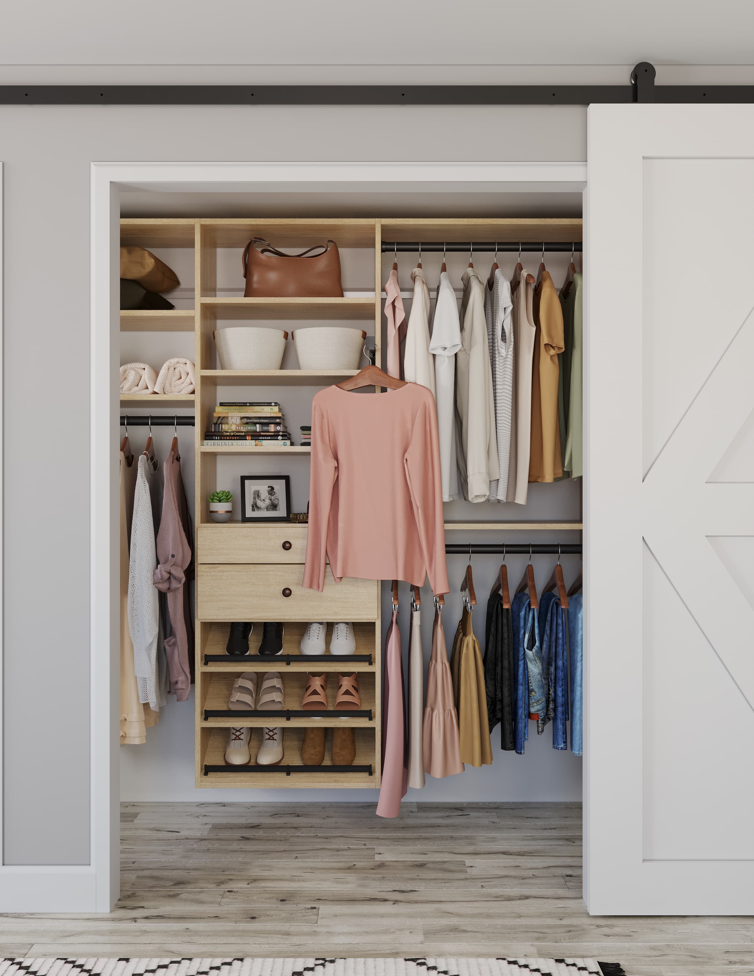 Reach-in closet with hanging, shelves, and shoe storage behind a barn door