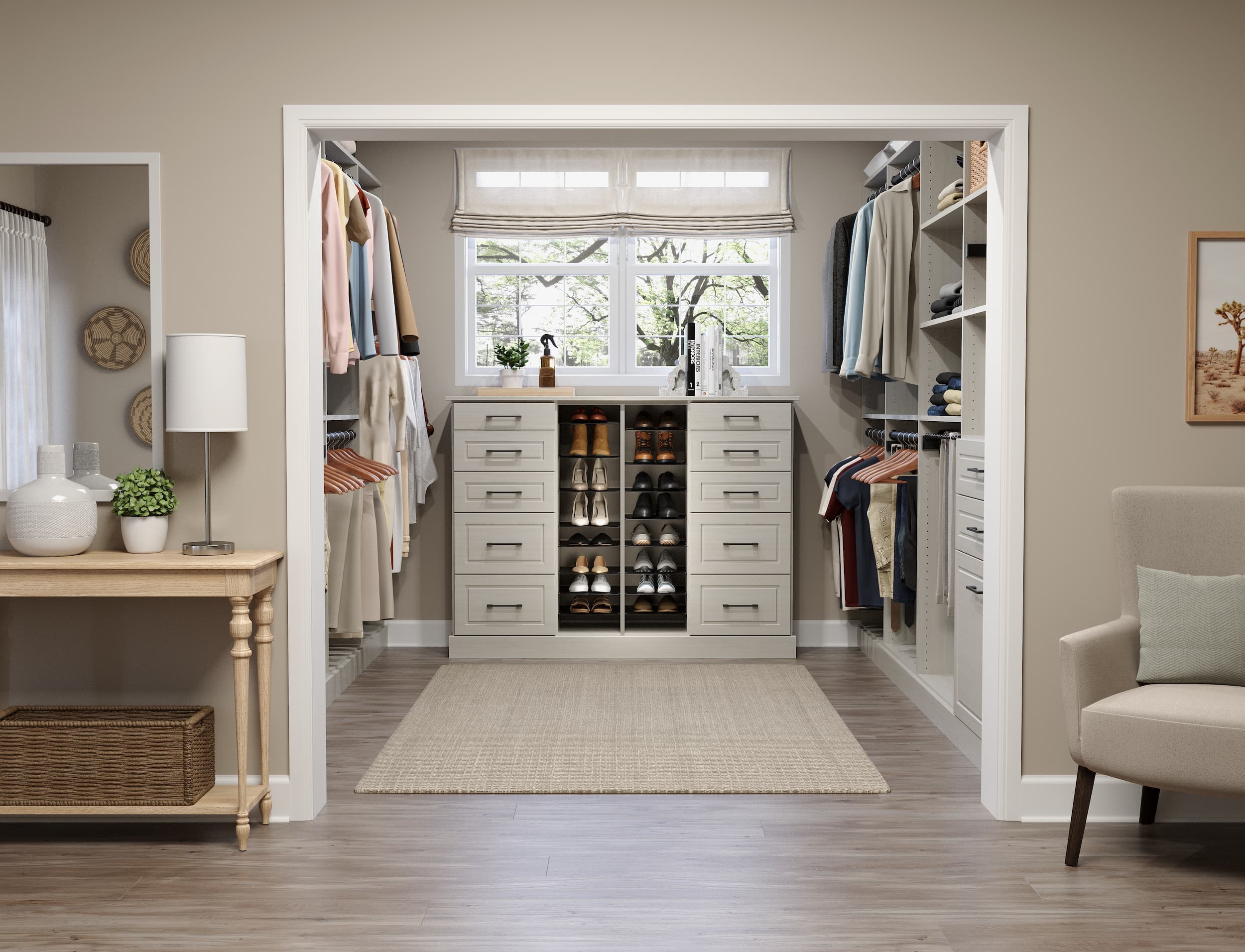 Wide view of a windowed walk-in closet with drawers, shoe storage, and hanging zones